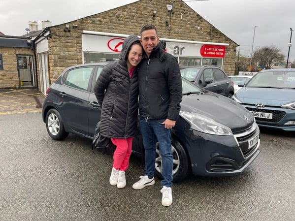 Despoina and her partner picking up their new Peugeot