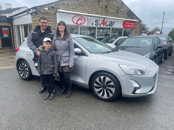 Samuel and his family from Leeds collecting their new focus