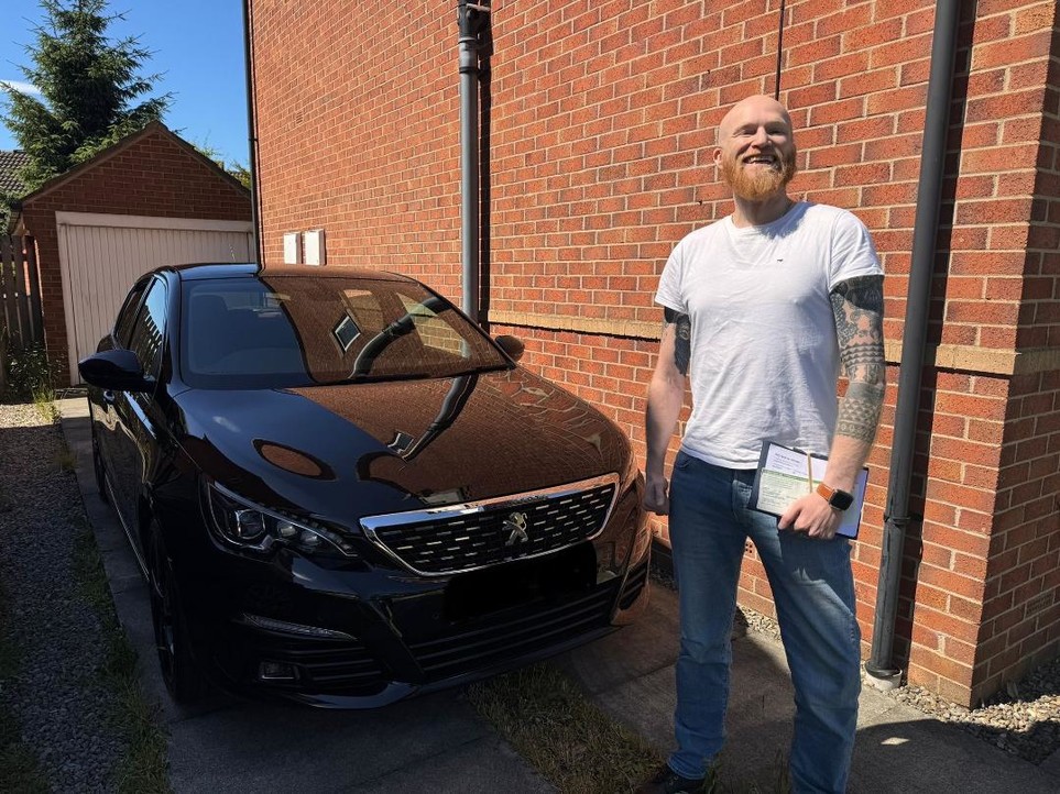 Jamie taking delivery of his new Peugeot. 
