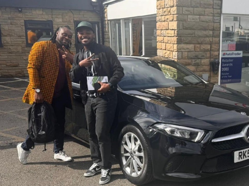 Dickson and his brother collecting their new Mercedes all the way from Croydon.