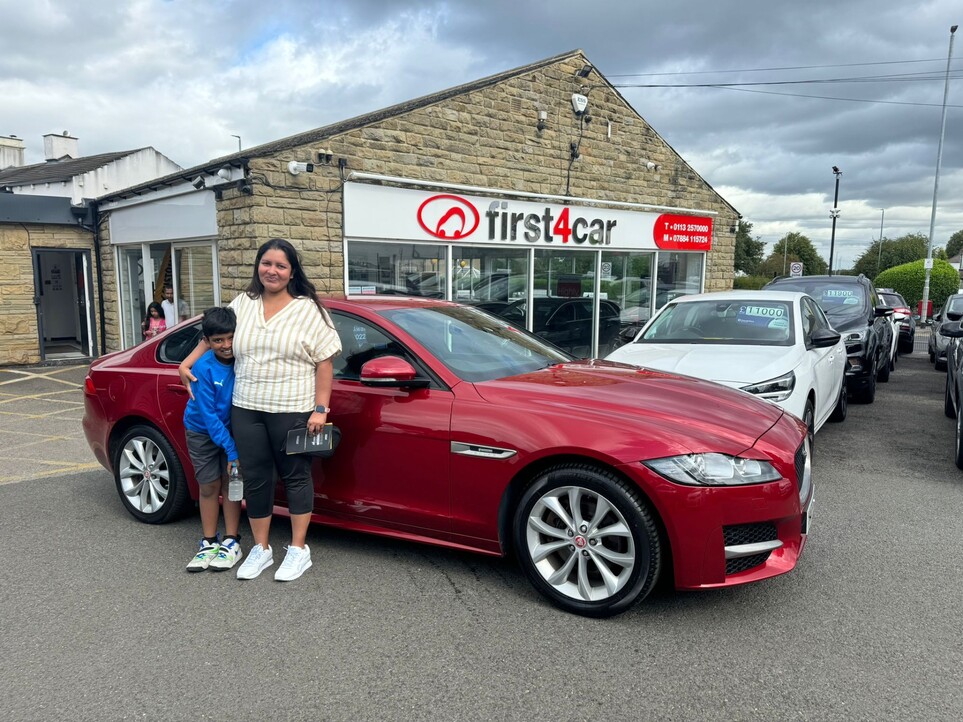 Dream and her son collecting their new Jaguar.