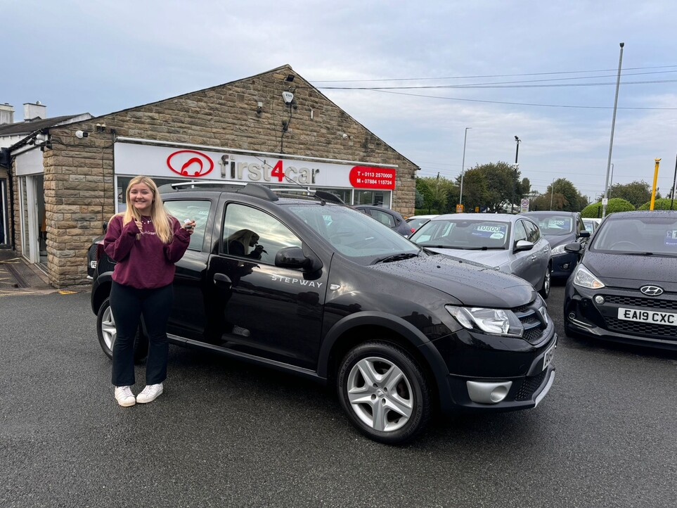 Elizabeth collecting her First car, a lovely Dacia Sandero.