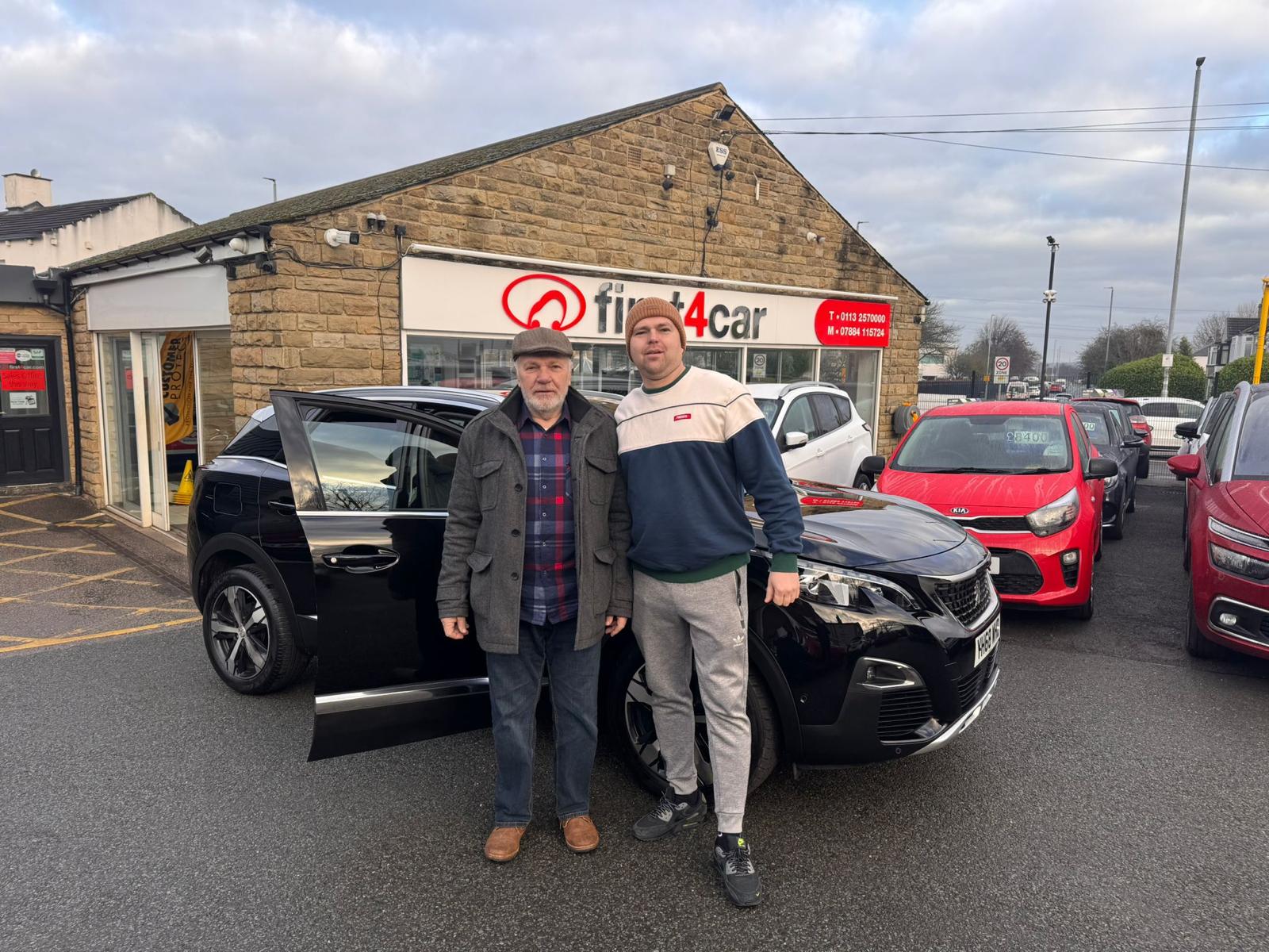 Mr Skibicki and his son collecting their new Peugeot