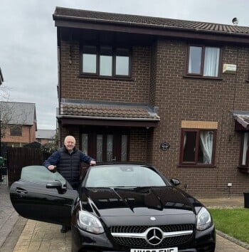 Paul taking delivery of his Mercedes SLC cabriolet in Manchester.