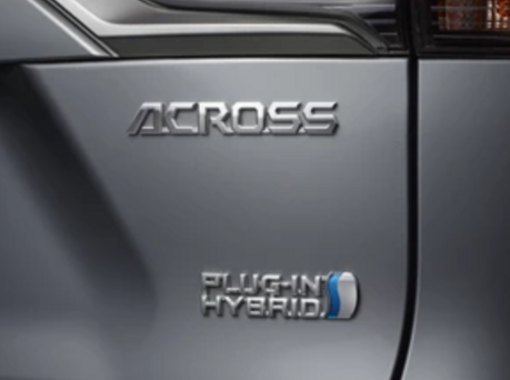 Close-up image of Across logo and Plug-In Hybrid text on Suzuki Across.