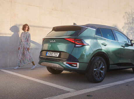 Image of someone walking out of a Kia Sportage.