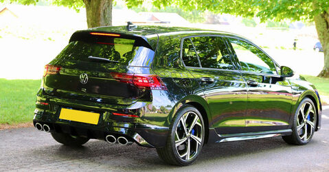 Black Volkswagen Golf R parked under trees at Simply VW 2025 in Beaulieu.